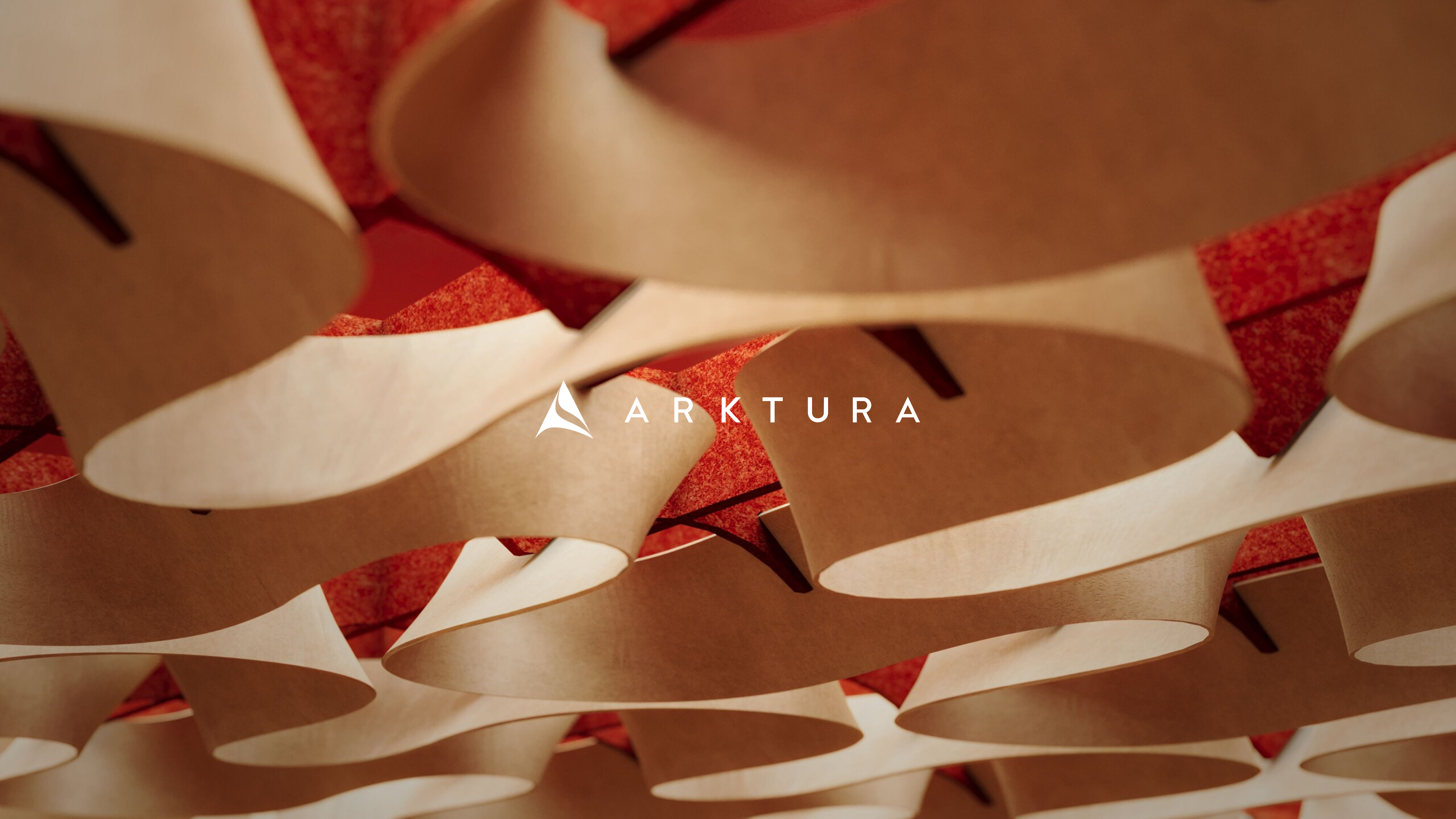 Curved, beige architectural panels are suspended from a red ceiling, creating an artistic wave pattern. The white ARKTURA logo and text—reflecting the Arktura website redesign—are centered over the image.
