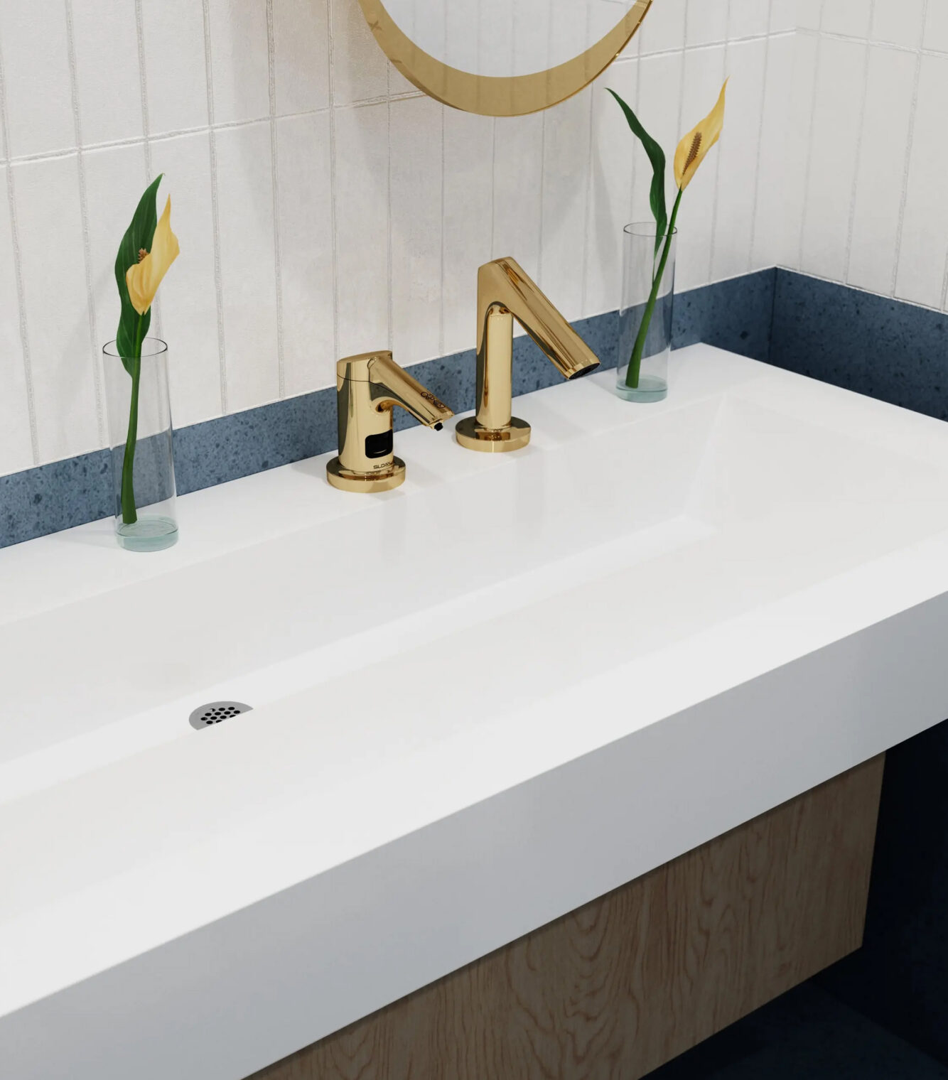 Minimalist commercial sink installation showcasing the gold-finish sensor faucet design.