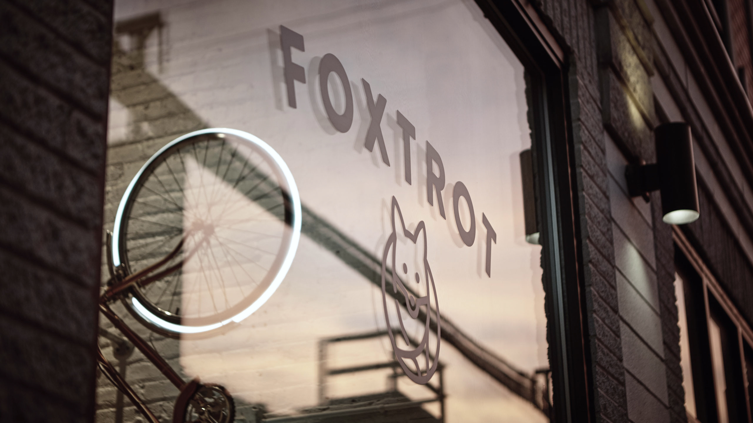The Foxtrot Delivery Market logo decal displayed on a storefront glass window.