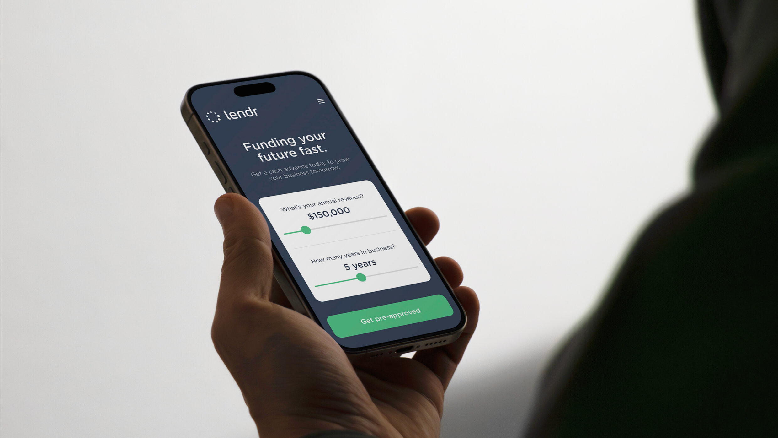 Close-up of a hand holding a smartphone displaying the Lendr mobile pre-approval interface.