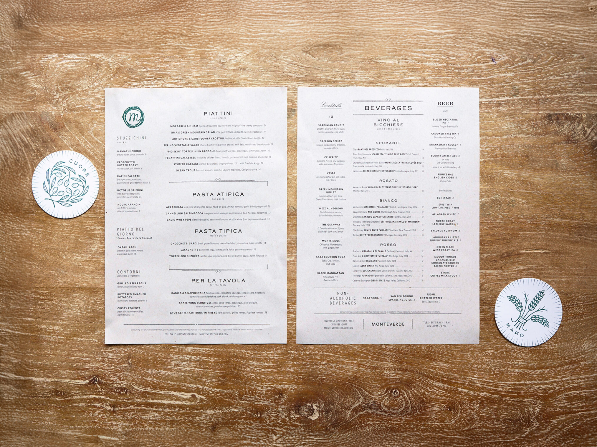 Monteverde restaurant food and beverage menus displayed flat on a wooden table with coasters.