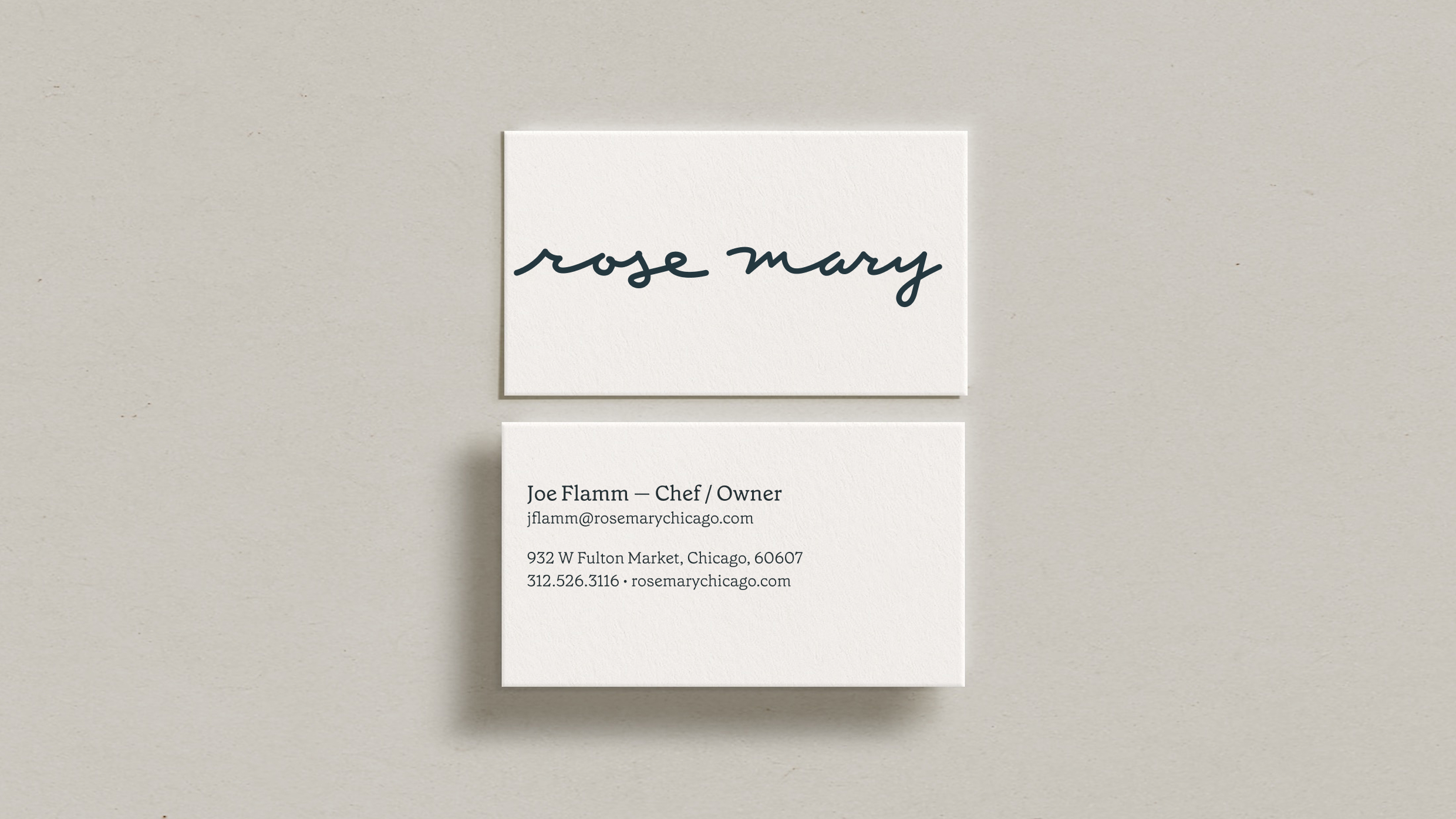 Two business cards on a light surface. The top card shows rose mary in cursive. The bottom card lists Joe Flamm, Chef/Owner, with contact info and address for Rose Mary in Chicago.