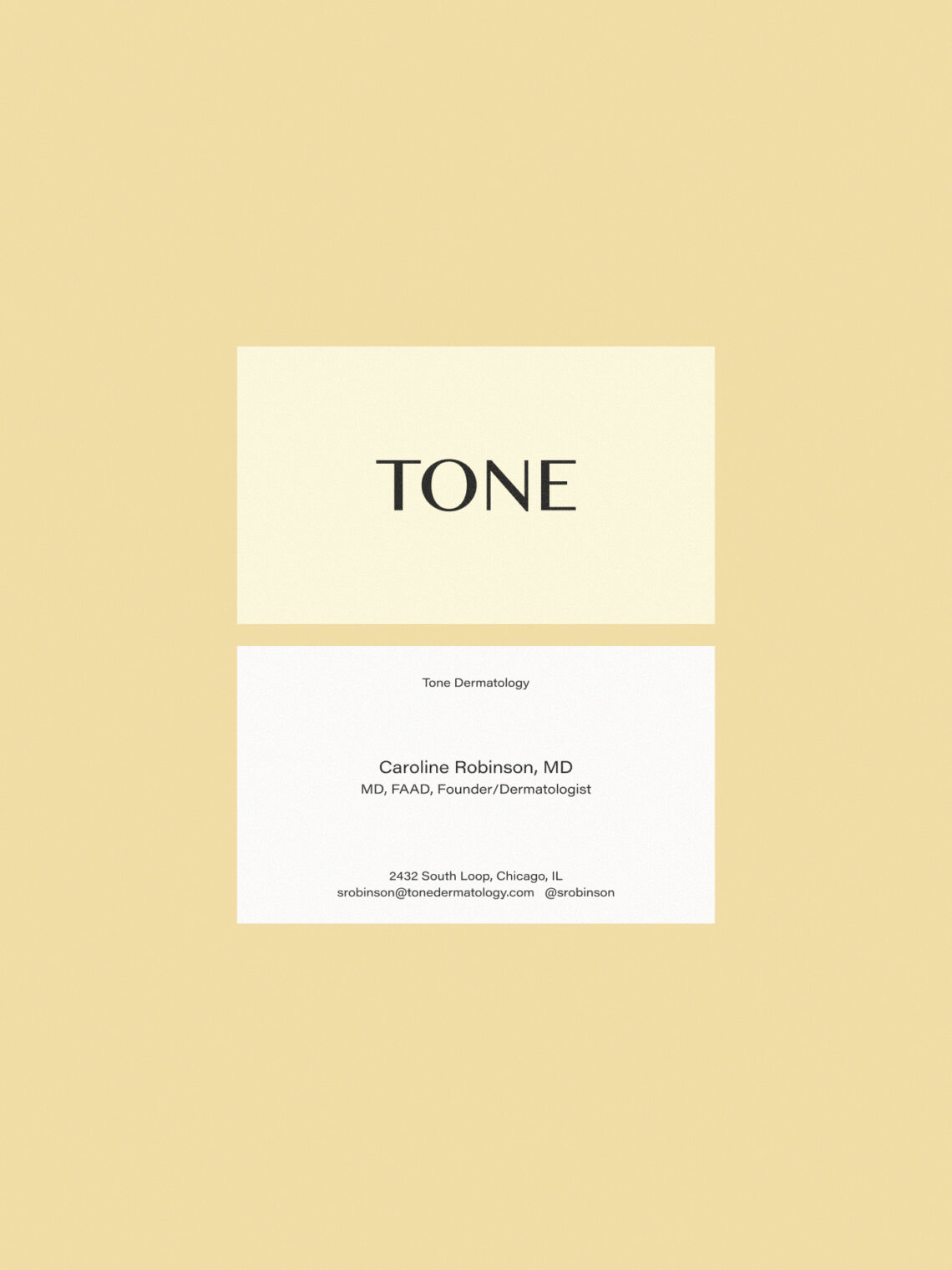 Minimalist business cards for Dr. Caroline Robinson at Tone Dermatology on a warm background.