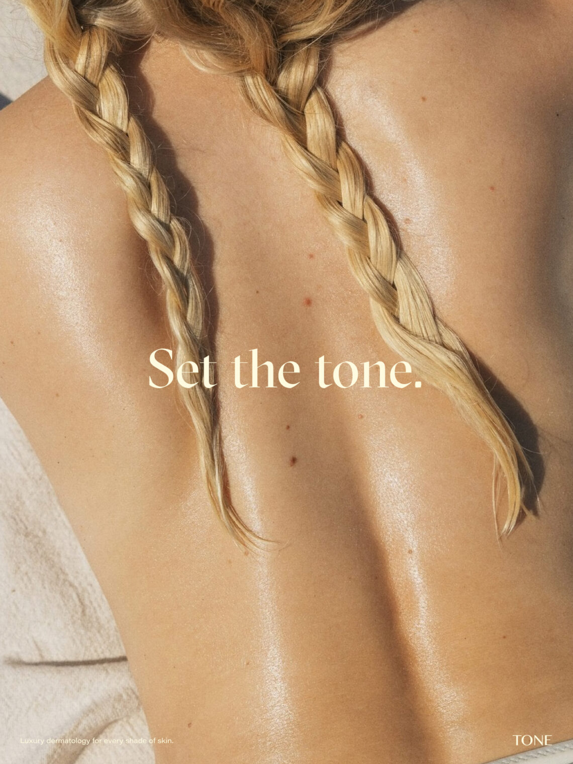 Tone poster showing a sunlit, hydrated back with blonde braids and brand text.
